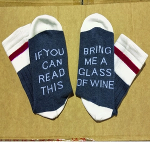 Detail view of cotton socks with funny If You Can Read This Bring Me A Glass Of Wine text