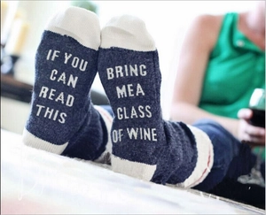 Detail of funny navy cotton socks with white lettering If You Can Read This Bring Me A Glass Of Wine