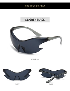 Detail view of futuristic grey black Y2K wrap-around sunglasses with flame cut-out edges