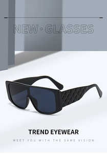 Close-up of black oversized sunglasses featuring stylish quilted textured temples and blue lenses