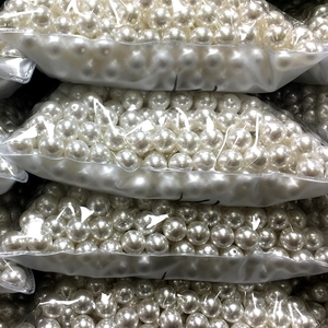 Bulk packs of round white ABS imitation pearls with smooth glossy finish for DIY jewelry