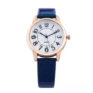Macro shot of gold quartz watch featuring a dark blue glitter strap and large numerals