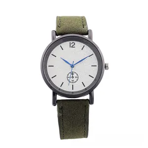Detail of dark green suede strap and matte black case with blue hands on a silver dial