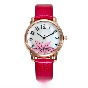 Detail of rose gold quartz watch with pink floral dial and textured leather strap