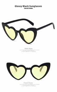 Front and side view of heart-shaped sunglasses with black frames and yellow lenses