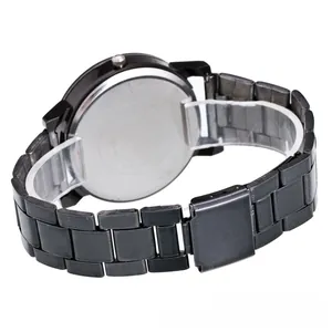 Detail of black stainless steel watch back with silver metal plate on acrylic stand