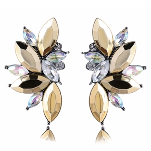 Macro detail of leaf-shaped earrings with iridescent gems and sparkling rhinestones