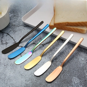 Set of six colorful 304 stainless steel butter knives on a dark stone tabletop