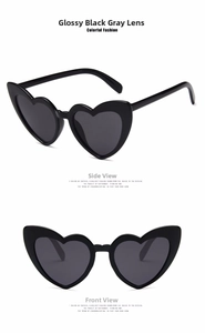 Detail view showing front and side profile of heart-shaped sunglasses in glossy black