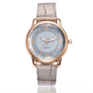 Macro detail of rose gold quartz watch with grey crocodile embossed leather strap