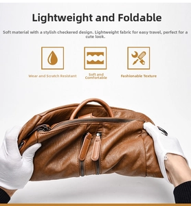 Detail showing the soft foldable brown PU leather material and dual zipper of the backpack