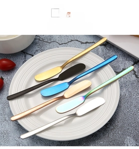 Set of 6 colorful 304 stainless steel butter knives on a plate in various finishes