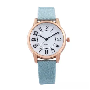 Macro detail of rose gold quartz watch featuring white dial and light blue glitter strap