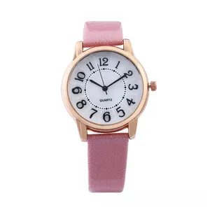 Detail of pink textured leather strap and rose gold case on women quartz watch