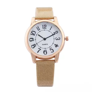 Detailed macro of a women's gold quartz watch with big numerals and glitter strap