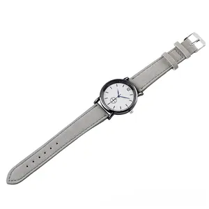 Close-up of minimalistic quartz watch with grey matte strap and black metal case