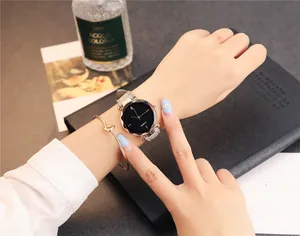 Gros plan d'une montre à quartz pour femme avec cadran en verre facetté et bracelet cuir