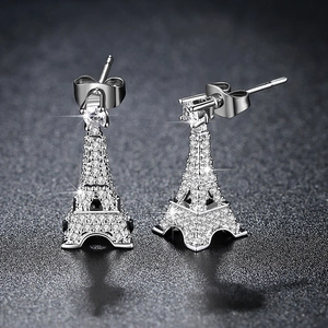 Elegant 3D Eiffel Tower earrings in silver finish with pavé zircon stones on dark background