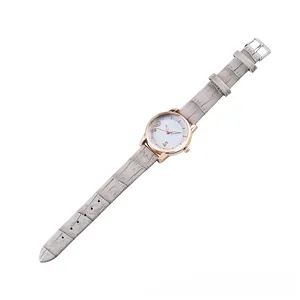 Detail view of stylish women quartz watch with grey leather strap and rose gold case