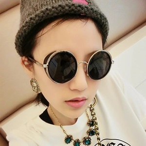Steampunk sunglasses with round silver frames and side shields worn by model