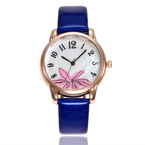 Women's rose gold watch with floral dial and dark blue leather strap on white background