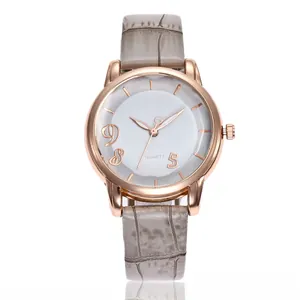 Close-up of women's watch with rose gold case and grey crocodile pattern leather strap