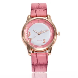 Detailed macro view of pink leather strap and rose gold quartz watch dial