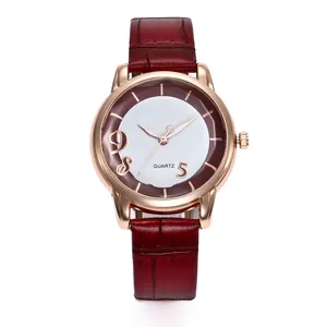 Close-up of the two-tone quartz watch dial with rose gold case and red leather strap