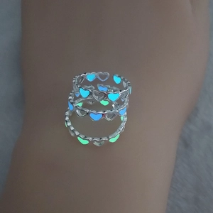 Three glowing hollow heart rings in silver finish with blue and green luminous effects