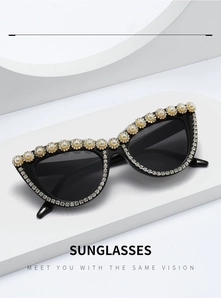 Detail of luxury cat eye sunglasses featuring faux pearl and rhinestone floral embellishments