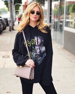 Street style shot featuring black oval vintage sunglasses and Titanic print hoodie