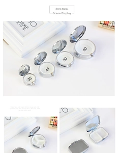 Close-up of a silver metal pill box with a built-in mirror and three internal compartments