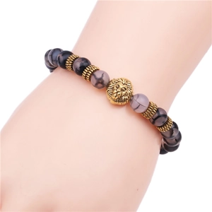 Neutral dragon vein agate beaded bracelet featuring a golden lion head charm on wrist