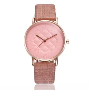 Detailed macro view of the rose gold roman dial and pink leather grid strap watch