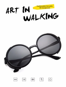 Detail view of round black frame sunglasses with high-definition resin lenses and sleek arms