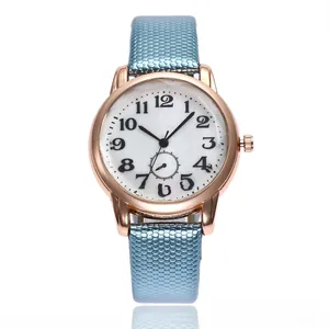 Detail of rose gold quartz watch with blue honeycomb strap and white numeric dial