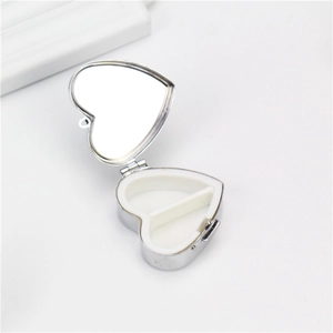 Portable heart-shaped silver metal pill box with dual compartments and built-in mirror