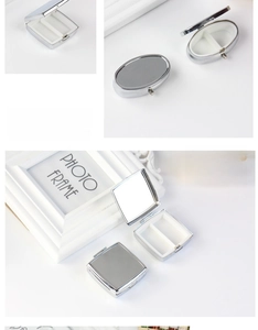 Detail of silver metal pill box with internal mirror and dual compartments