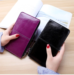 Detailed view of long zipper wallets in purple and black PU leather with wrist straps