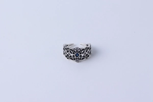Macro shot of S925 silver mark on vintage hollow ring with blue gemstone inlay