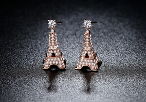 Macro shot of rose gold Eiffel Tower earrings featuring sparkling cubic zirconia stones