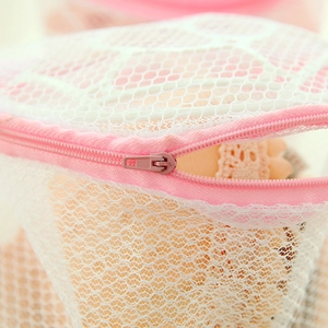 Pink foldable mesh laundry bag for bras featuring a fine mesh and protective zipper