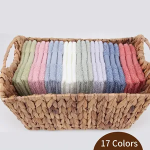 Set of soft absorbent pure cotton towels in 17 colors neatly folded in a woven basket