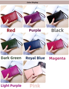 Close-up of eight colorful leather long wallets with wrist straps and metal zippers
