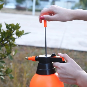 2L high-pressure manual pump sprayer with orange plastic body and metal spray wand
