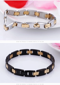 Detailed close-up of two-tone stainless steel bracelets with H-shaped links in silver and gold