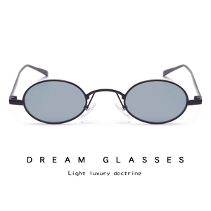 Detail of oval thin metal sunglasses with grey lenses and soft silicone nose pads