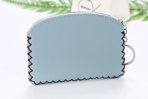 Detailed macro view of light blue PU leather coin purse with sawtooth stitching