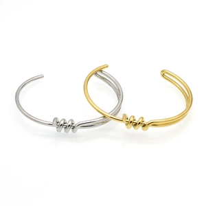 Modern gold and silver minimalist open cuff bangles with spiral knot design for women