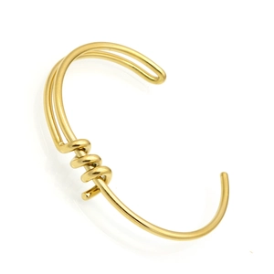 Detail of a minimalist gold-plated open cuff bracelet with dual-line twisted design